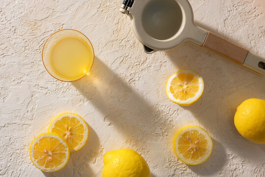 Fresh Lemon Juice and Slices with Juicer on Rustic Background