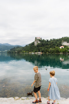Two kids in front of lake and castle Bled, Slovenia