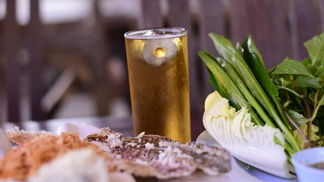 Grilled fish with Thai spicies salad , in Thai cal "Miang Pla Pao" on the table, Miang Pla Pao, Grilled fish with vegetables and cold beer