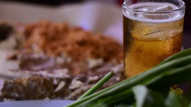 Grilled fish with Thai spicies salad , in Thai cal "Miang Pla Pao" on the table, Miang Pla Pao, Grilled fish with vegetables and cold beer