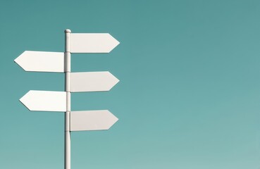 Five white blank street signs point directions. Signs on metal post against blue sky. Signpost shows way to go. Transportation, business, travel destination, navigation concepts.