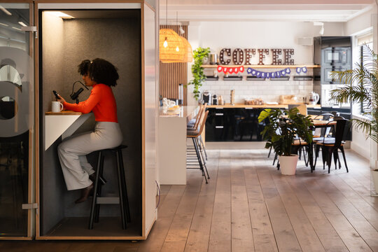Modern Office Workspace with Phone Booth and Break Room