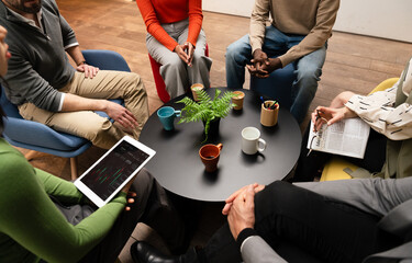 Collaborative team meeting with diverse individuals at table