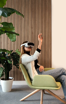 Woman Engaging with Virtual Reality Headset in Modern Setting