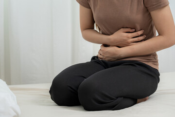 stomach ache. Asian women have abdominal pain, indigestion, gastritis, menstrual cramps,...