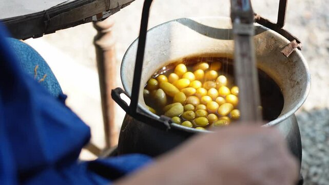 Wheel spinning yarn with yellow thread to work for weaving machine and Thai traditional silk. Step by step of traditional weaving.