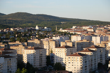 Fototapeta premium Cityscape view of residential buildings and mountains in daylight