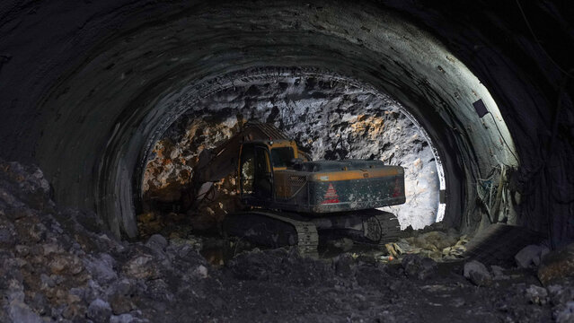Excavator excavating in Tunnel Construction