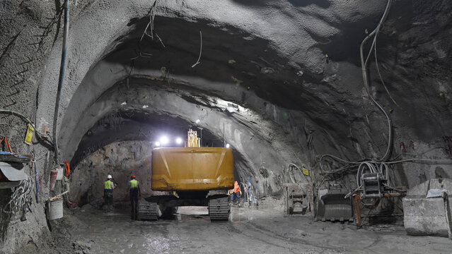 Construction Workers Operating Machinery in Ongoing Tunnel Work