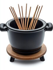 Elegant Black Pot with Natural Wood Base and Cooking Sticks - Minimalist Kitchen Design