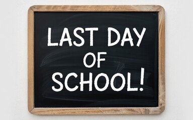 Chalkboard displaying 'Last Day of School!' in bold white letters, marking the end of the academic year.