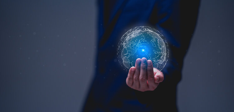 Businessman holds a glowing digital globe, symbolizing global connectivity and technology in a modern context.