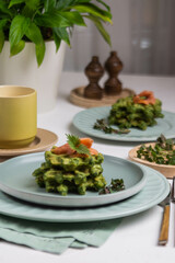 Healthy eating. Spinach and fish waffles for breakfast.