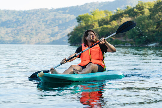 Man paddling a kayak on a lake