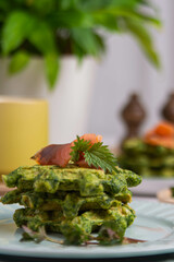 Healthy eating. Spinach and fish waffles for breakfast.