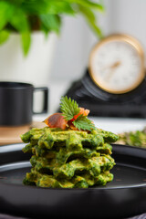 Healthy eating. Spinach and fish waffles for breakfast.
