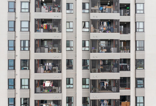 Residential Building Facade with Balconies and Daily Life Signs