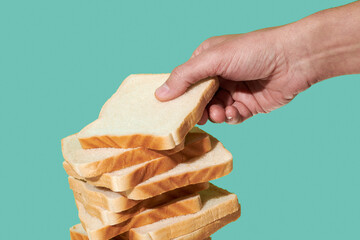 man takes a slice of sandwich bread