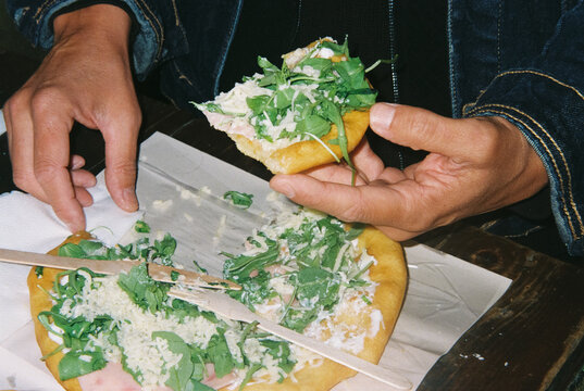 man eating a hungarian langos in Budapest, 35mm