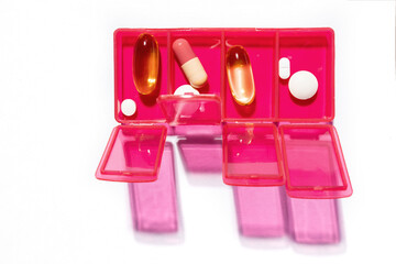 Everyday medications lie in a colorful pillbox 