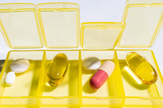 Everyday medications lie in a colorful pillbox 