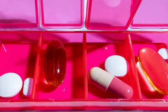 Everyday medications lie in a colorful pillbox 