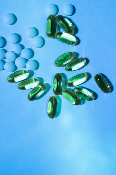Pills and capsules in blue light