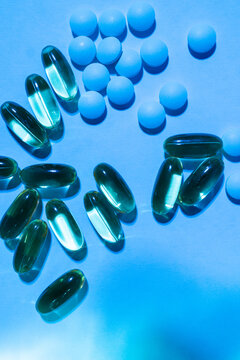 Pills and capsules in blue light