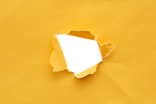 Torn ripped yellow paper hole isolated on white background