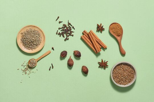Natural Spices Arrangement on Green Background Featuring Cloves