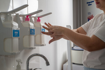 Woman washing her hands thoroughly with soap