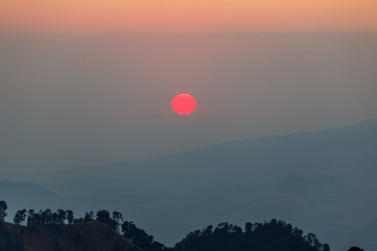 Red sun rising over iztaccihuatl volcano in mexico at dawn