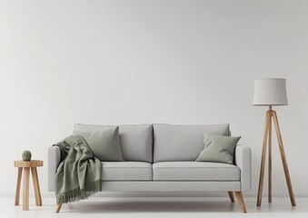 Modern minimalist living room with light gray couch, sage green throw pillows and blanket, wooden stool and lamp