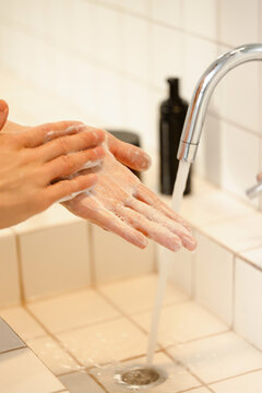 Hand washing in the sink with soap