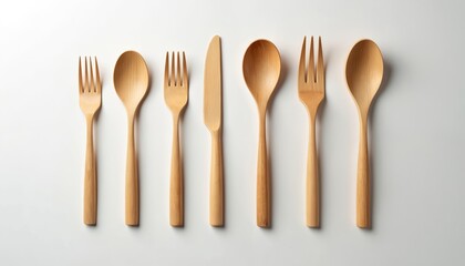 Wooden cutlery set isolated white background. Eco-friendly bamboo fork spoon knife set for picnic lunch dinner. Sustainable reusable tableware design. Natural minimal lifestyle. Top view, flat lay.