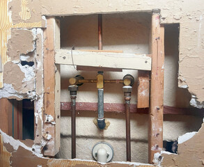 Open Bathroom Wall with Pipes Home Renovation