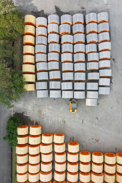 Aerial view of organized cable spools in a factory yard.