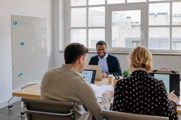 Formal business people working together on project in modern office