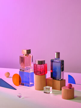 Colorful Perfume Bottles Displayed on Geometric Abstract