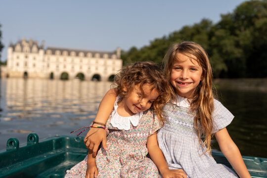 siblings sitting on a barque, exploring France&rsquo;s parks and castles.
