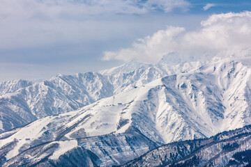 Towering snow covered mountain peaks. Alpine scenery