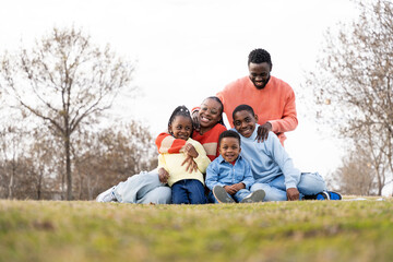 Happy african american family enjoying time together in park