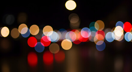 Nocturnal Cityscape: Abstract Bokeh of Warm & Cool Lights Reflecting on Wet Pavement