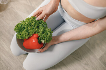Cropped photo of woman with lots of healthy fresh vegetables on a plate