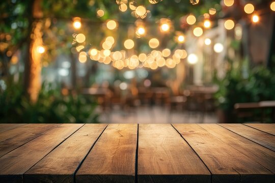 Empty wooden table outdoors at night with warm lighting. Bokeh background of patio seating area - Powered by Adobe