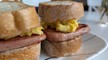 Close up of two breakfast sandwiches on a plate 
