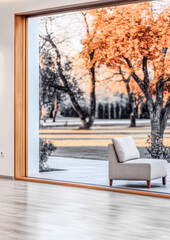 Modern interior design showcasing autumn landscape through a large window at dusk