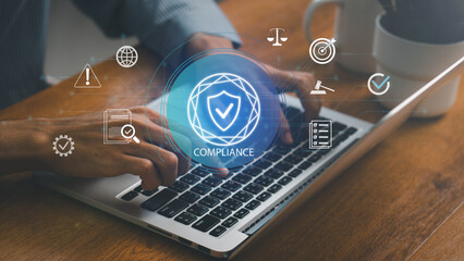 Compliance in business concept. Laws concept. Enforce laws, regulations and standards, comply with business policies, Businessman use laptop with compliance icon on virtual screen.