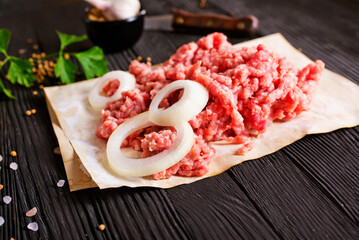 Raw minced pork. Black background. Top view. Space for text