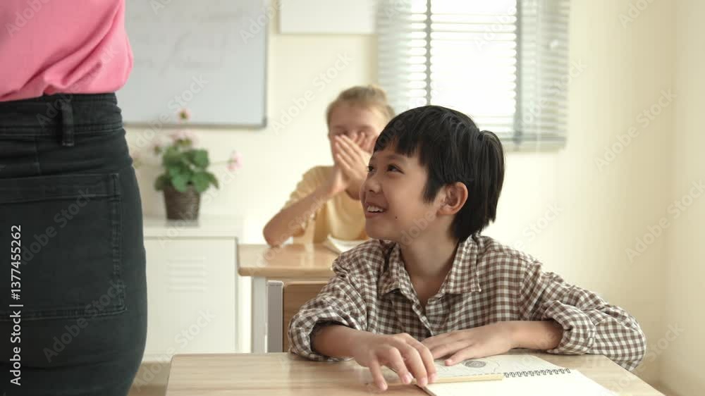 Poster asian elementary student looking at teacher while attend in classroom. diverse smart student sitting